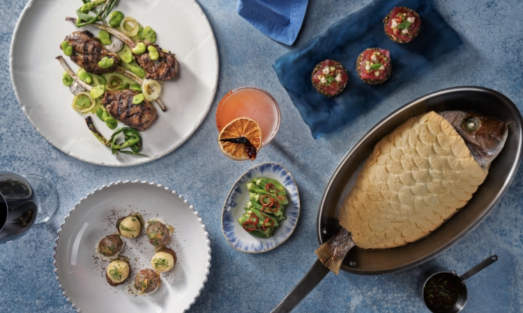 variety of elegantly plated gourmet food and drink on a table