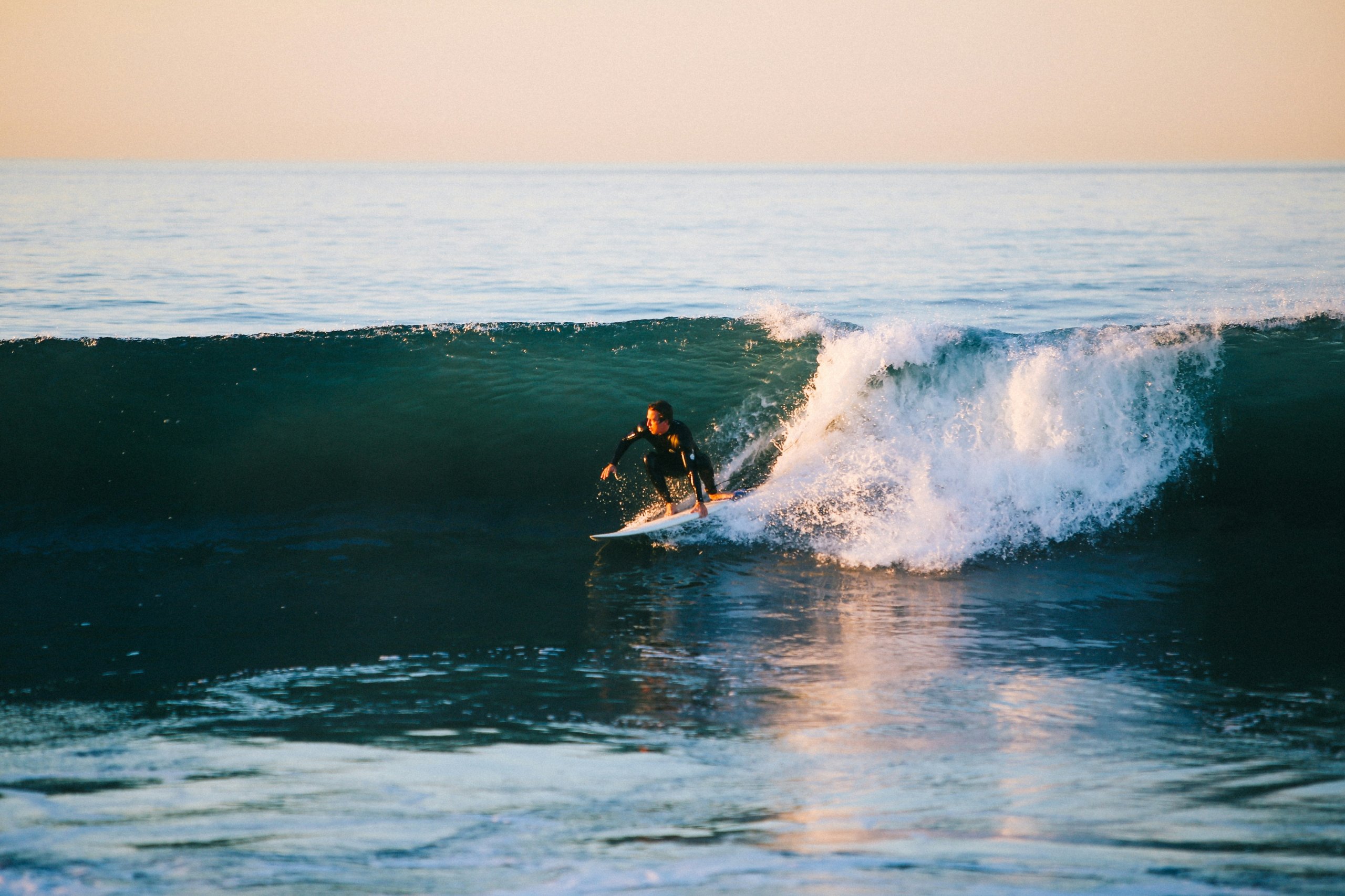 a surfer rides a wave on a surfboard