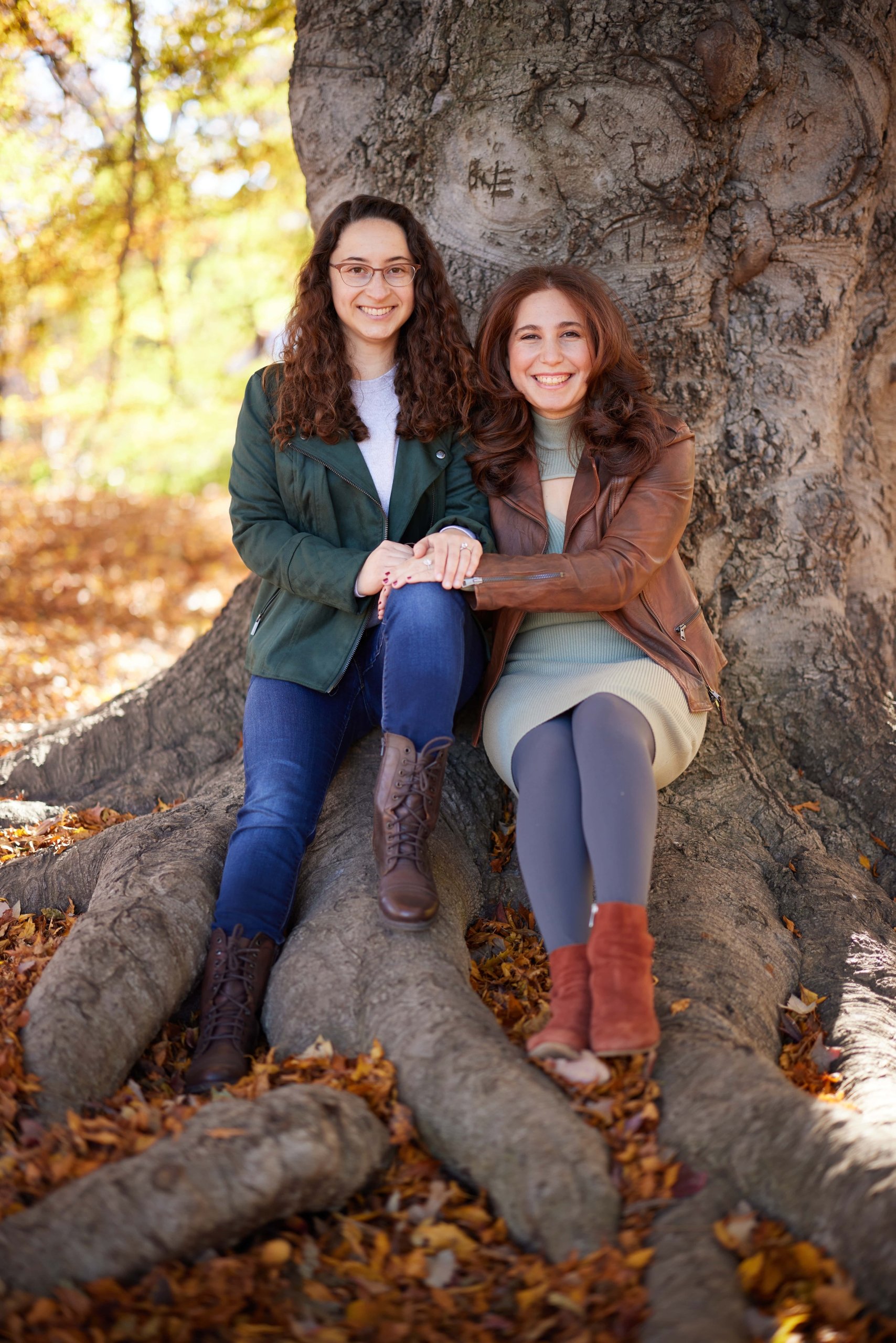 Couple seated for a portrait under a tree