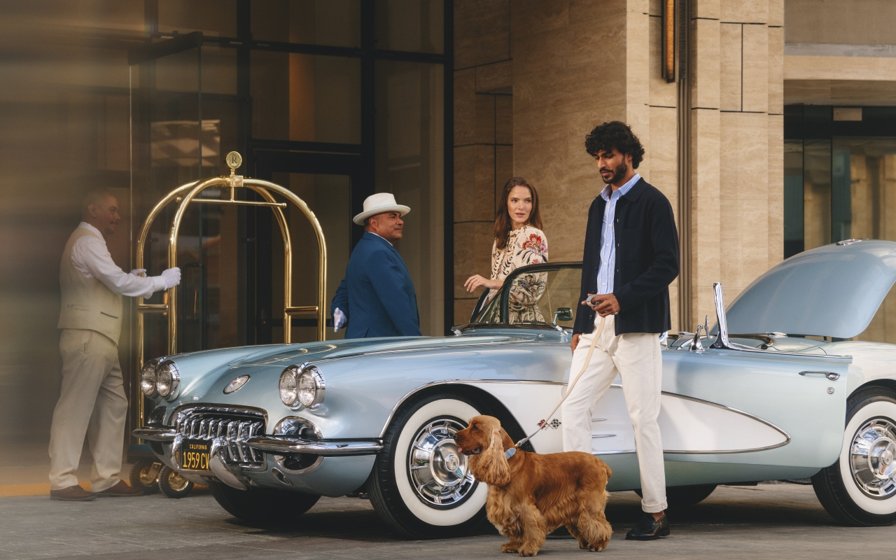 Couple with pet arriving at Regent Santa Monica
