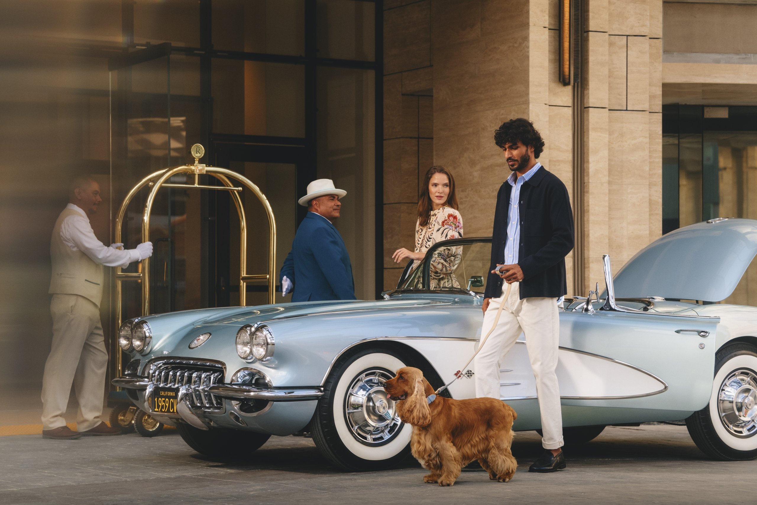 Couple with pet arriving at Regent Santa Monica