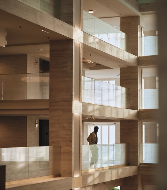 Man enjoying view of lobby from second floor