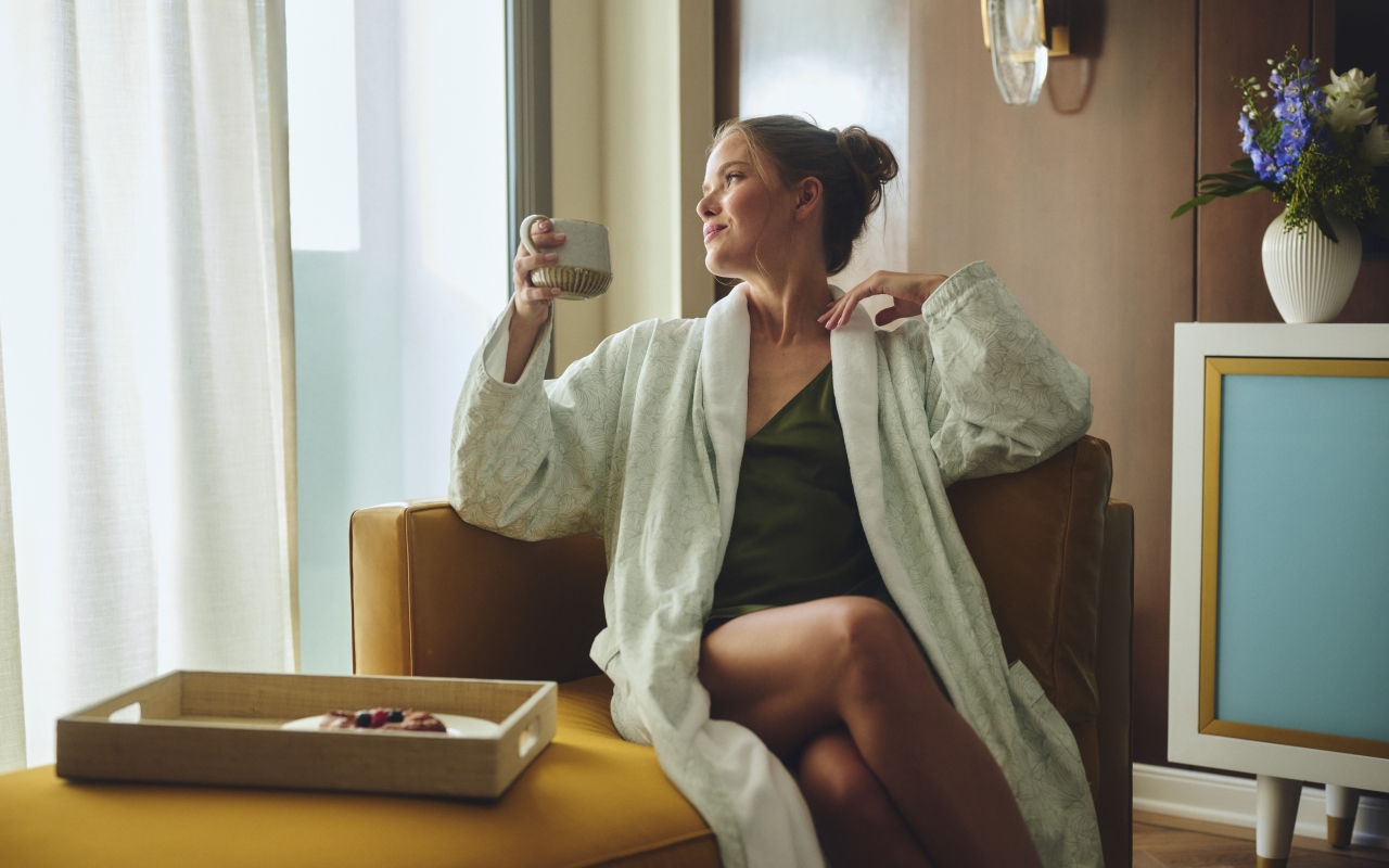 Women with coffee relaxing in the morning in hotel room