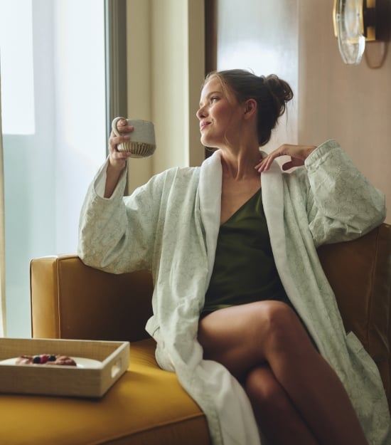 Women with coffee relaxing in the morning in hotel room