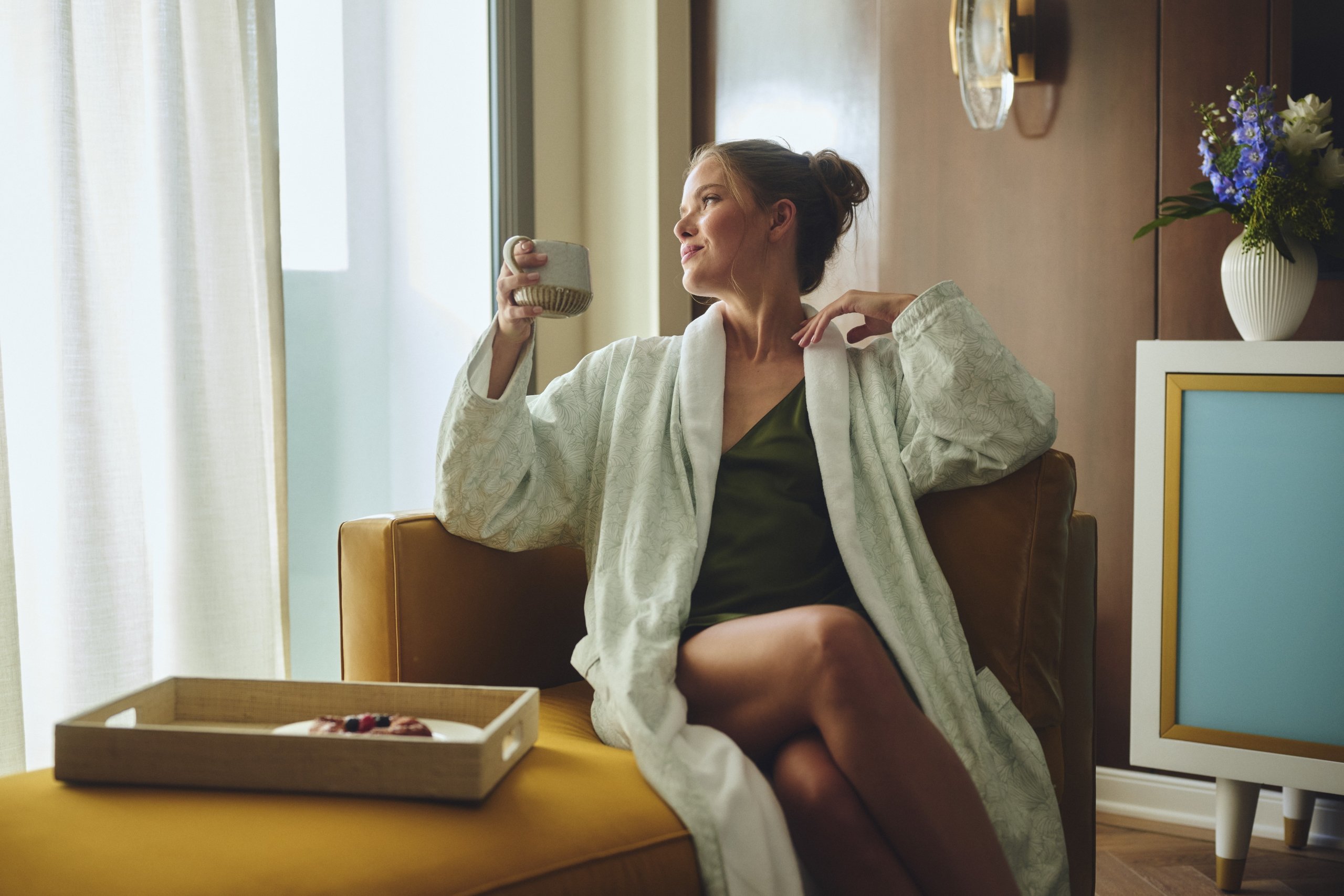 Women with coffee relaxing in the morning in hotel room