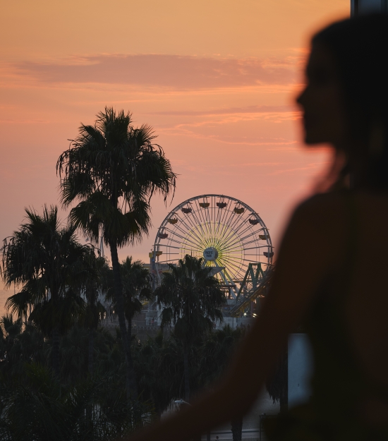 woman in balcony watching the sunset