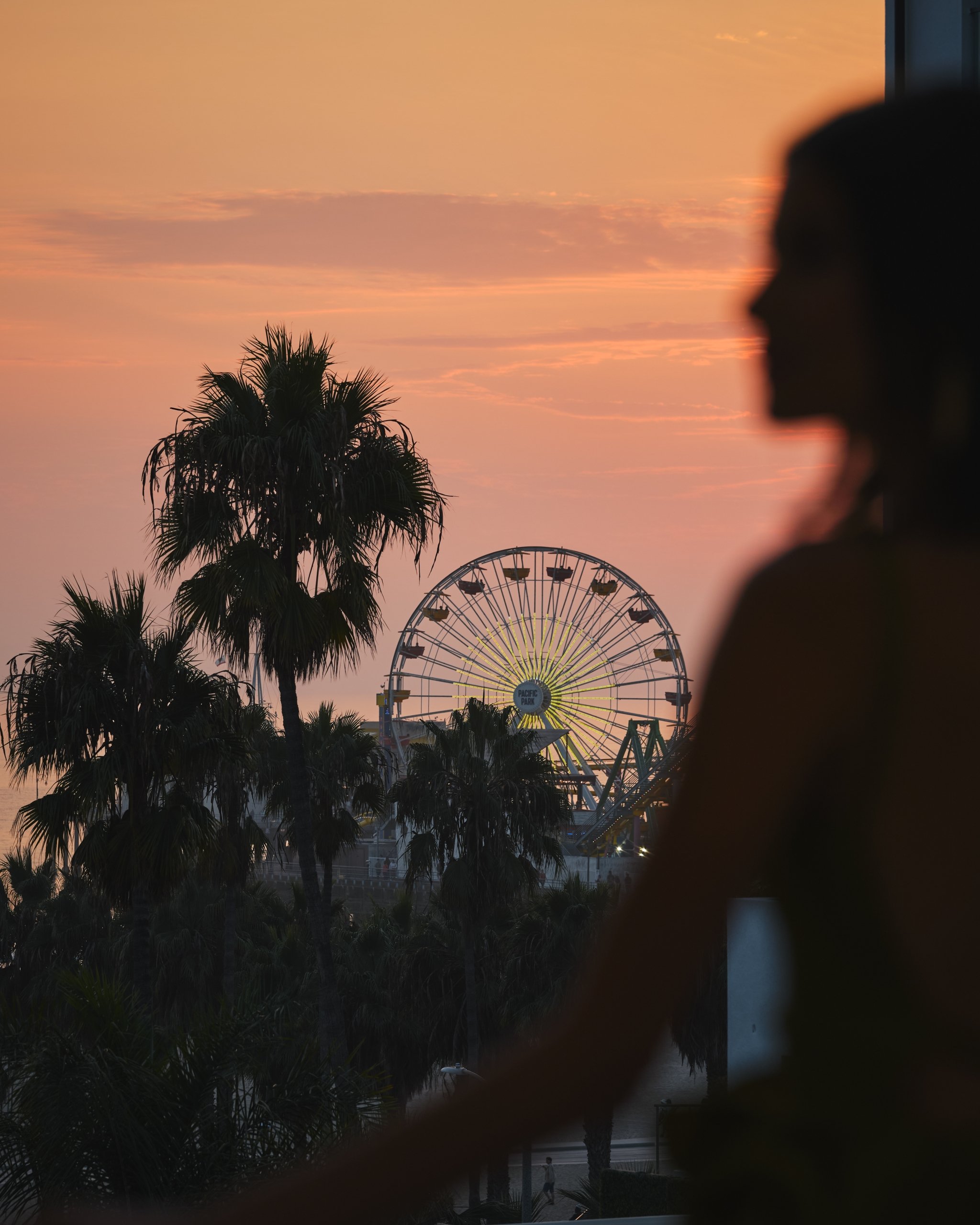 woman in balcony watching the sunset