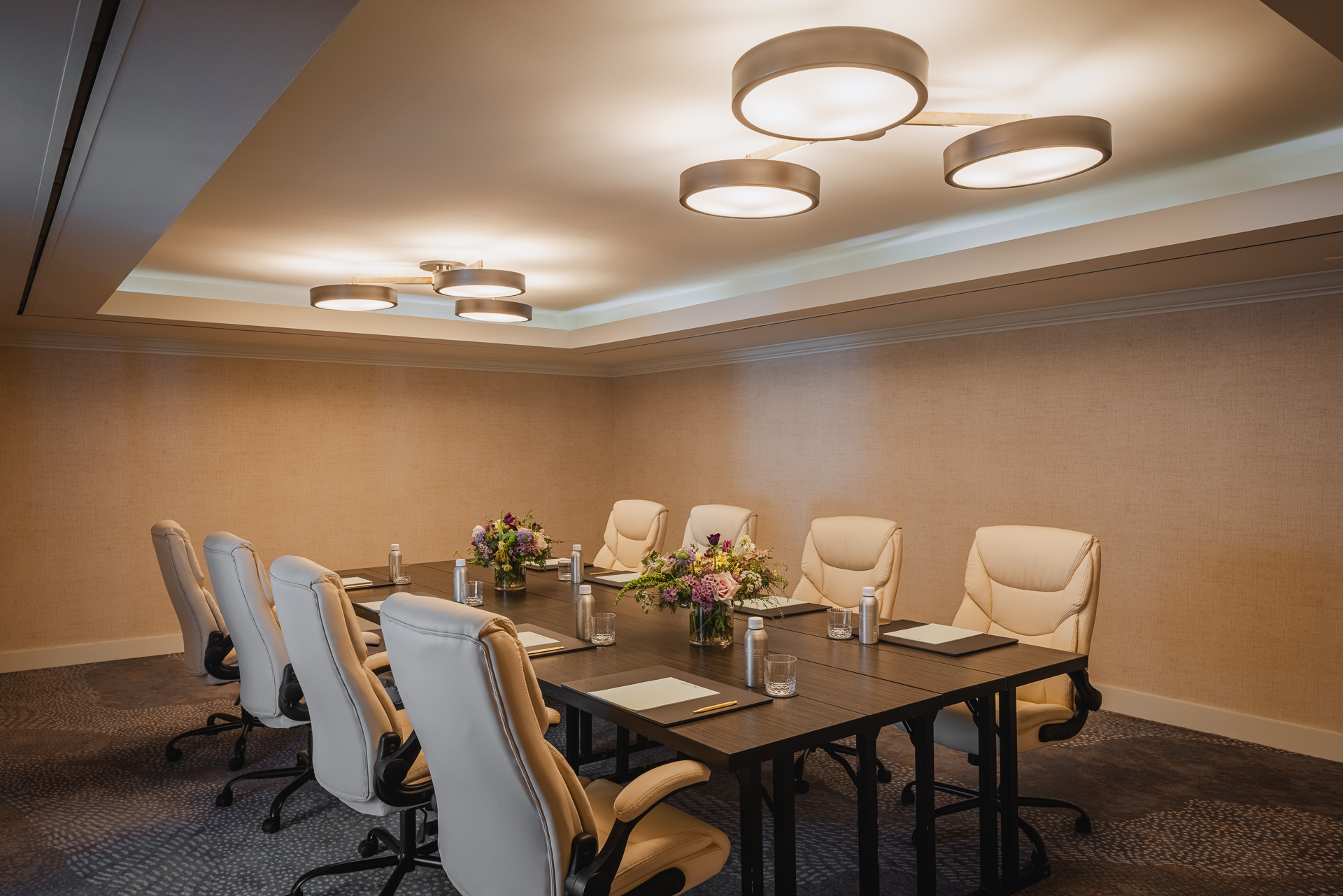 Boardroom with eight chairs set up for a meeting