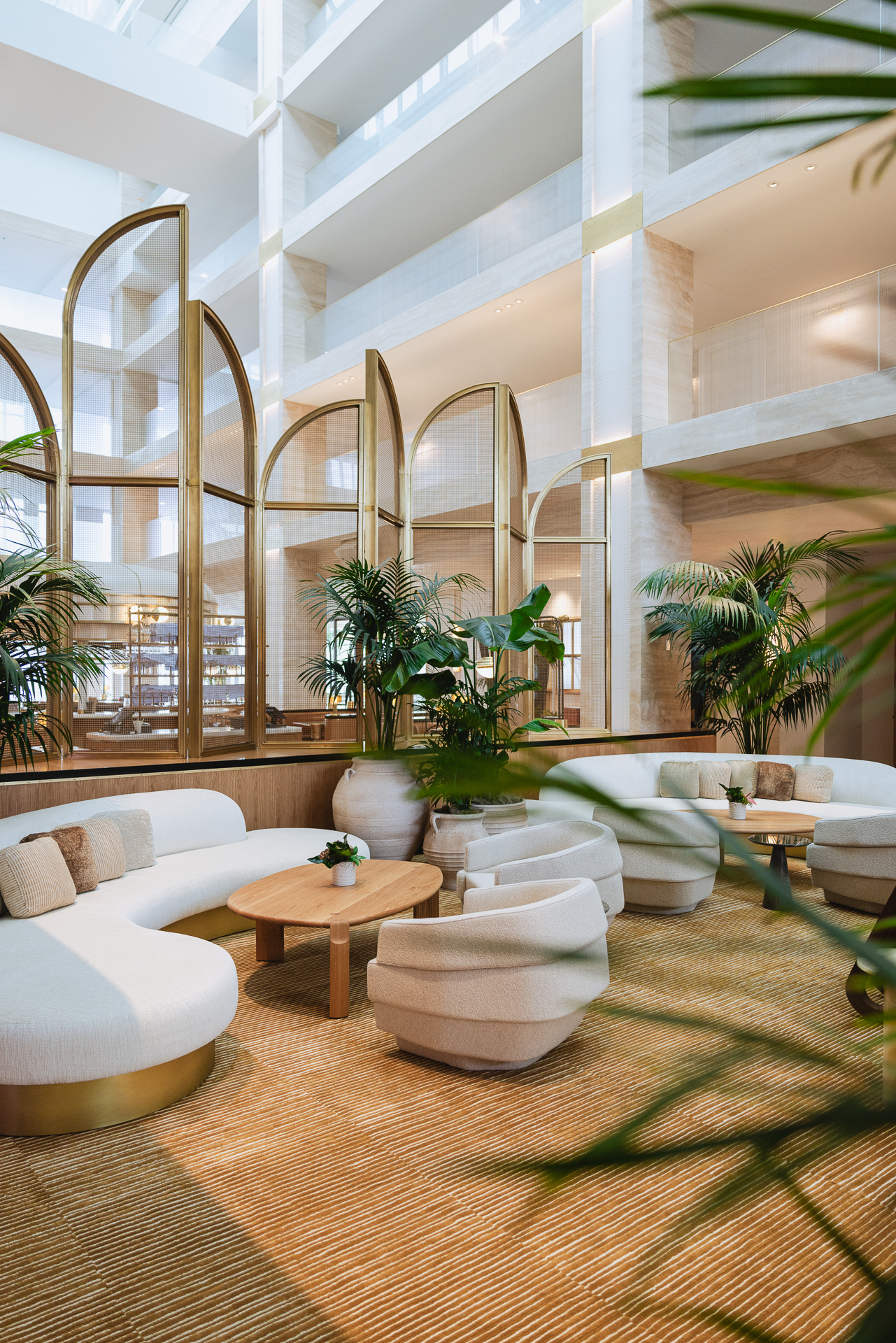Hotel Lobby with framed brass arch ways and furniture