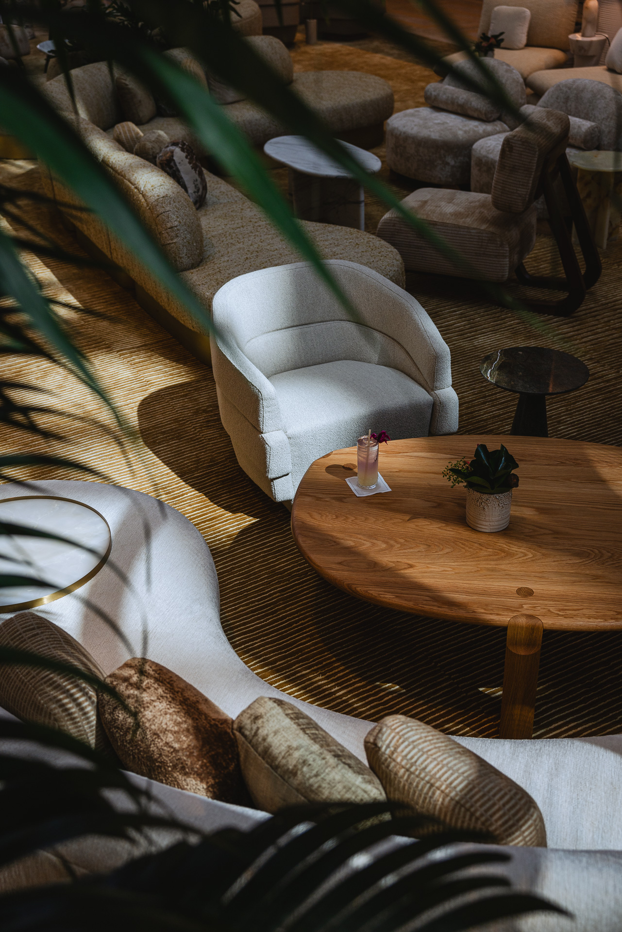 Views of lobby furniture through tropical trees