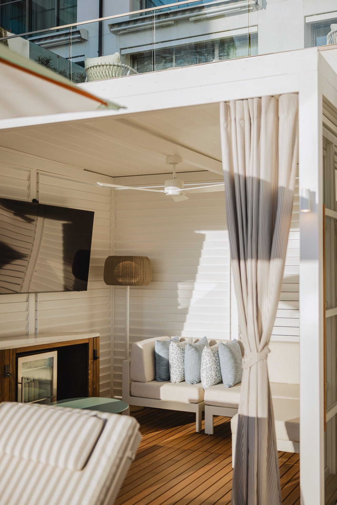 Cabanas poolside with fan and couch