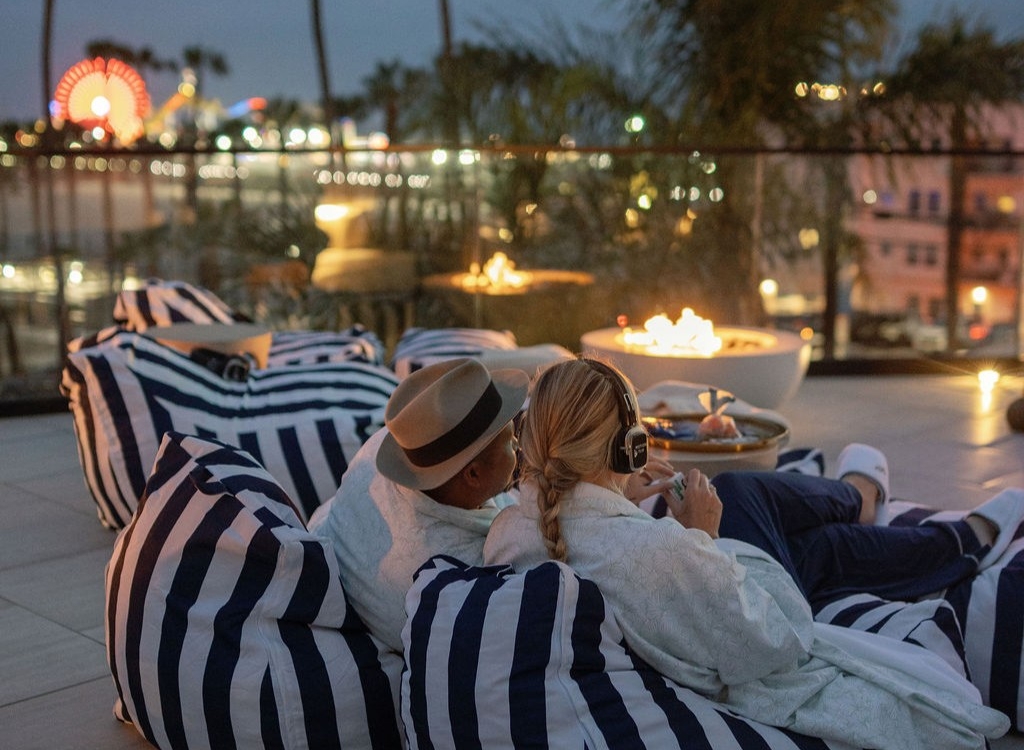 People watching movies on the big screen by the beach