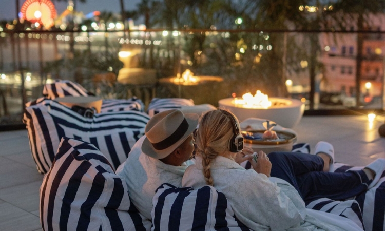 People watching movies on the big screen by the beach